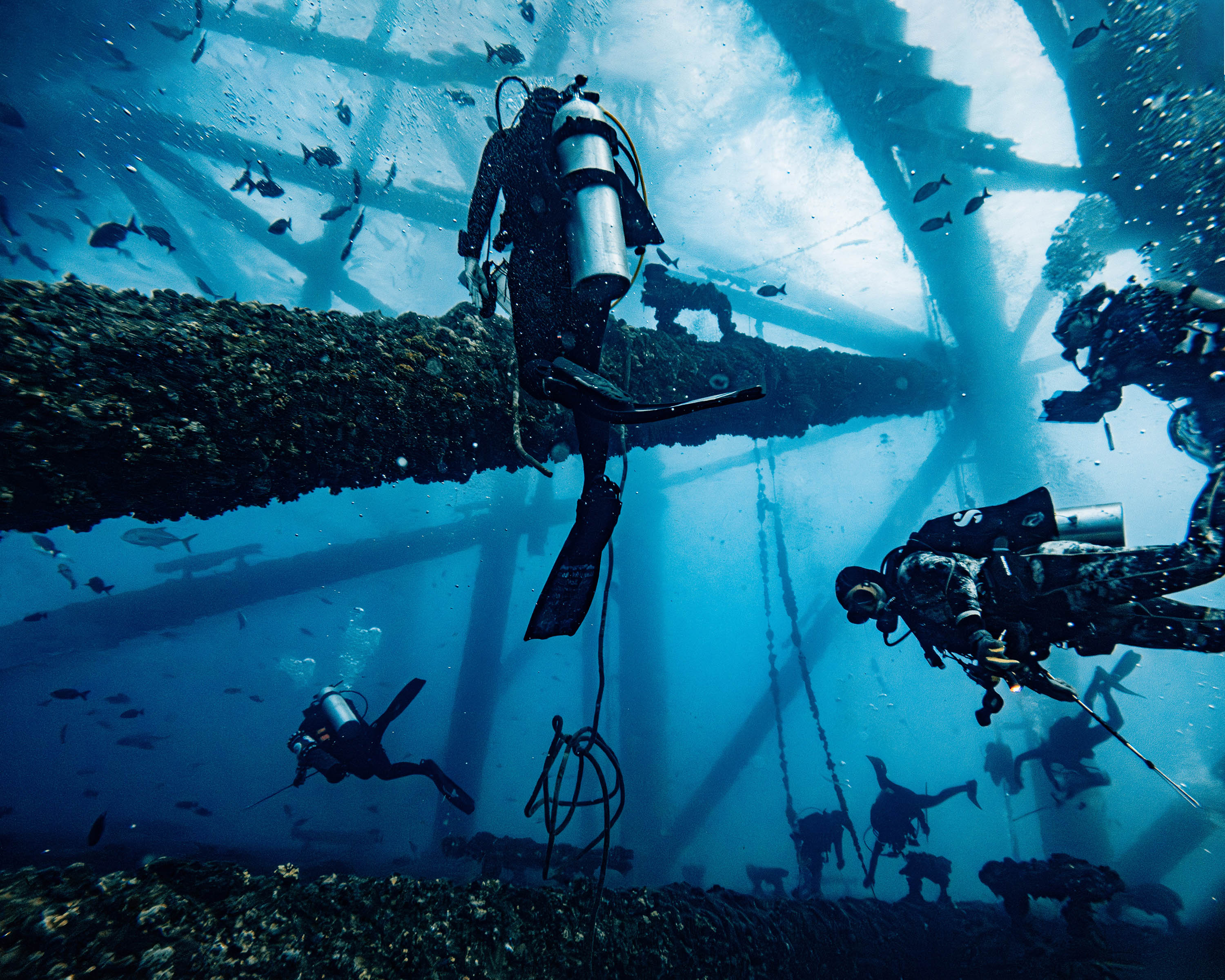 Divers working beneath offshore structure at Flower Garden Banks sanctuary - 16x20 metal print
