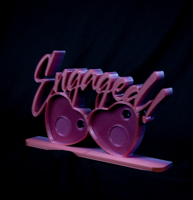 Engaged photomagnet frame holding two heart-shaped magnets for couples