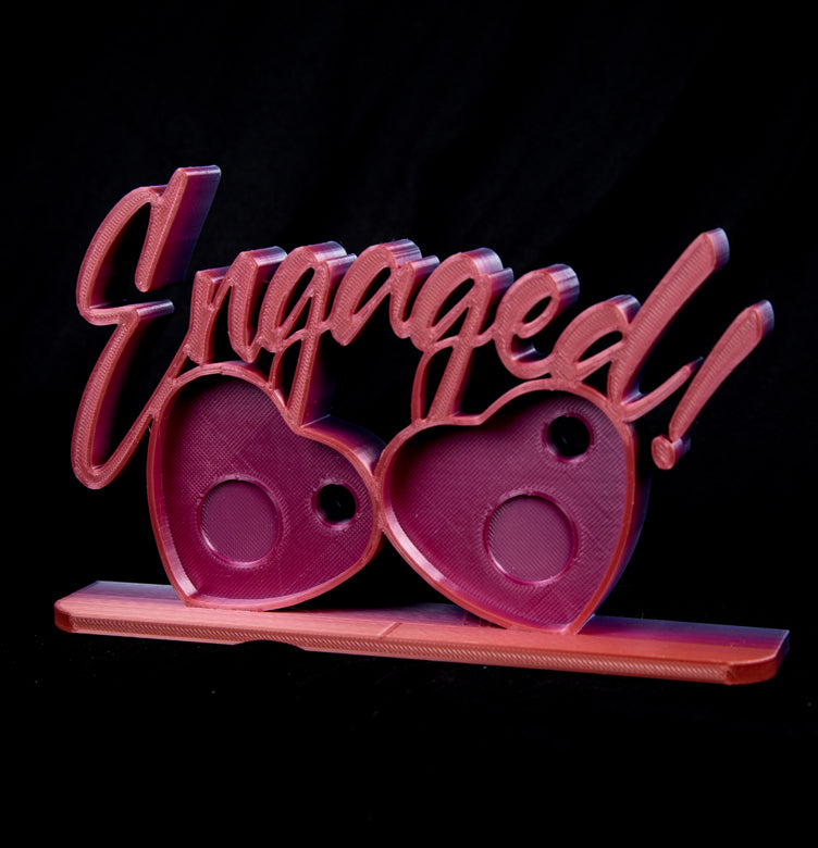 Engaged photomagnet frame holding two heart-shaped magnets for couples