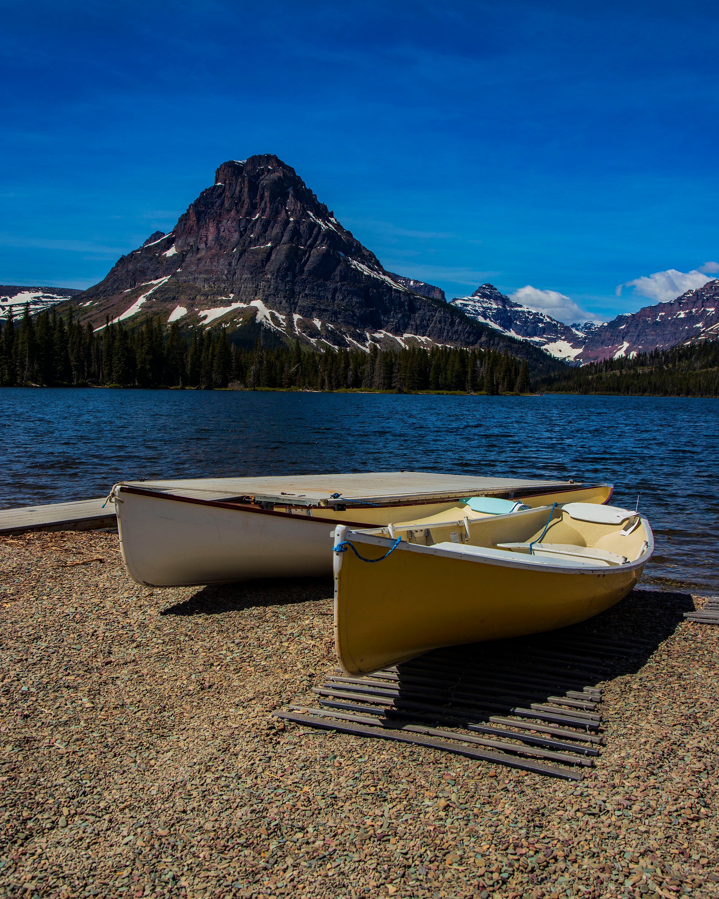 Two canoes on rocky shore of St. Mary Lake in Glacier National Park - 16x20 metal print